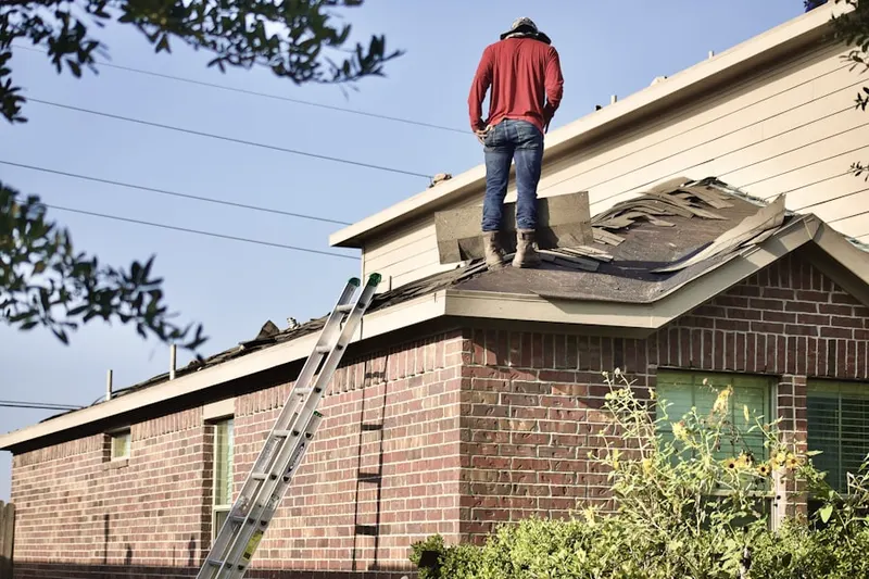 Professional roofer working on a residential roof in Delanco